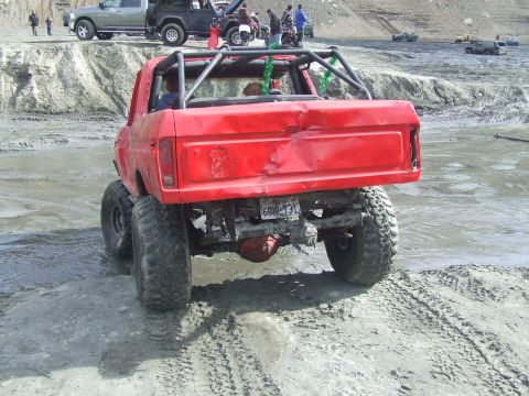 1978 Ford Bronco - This heavily modified 1978 Ford Bronco is equipped with a roll cage and dual rear wheels, seen off-roading.