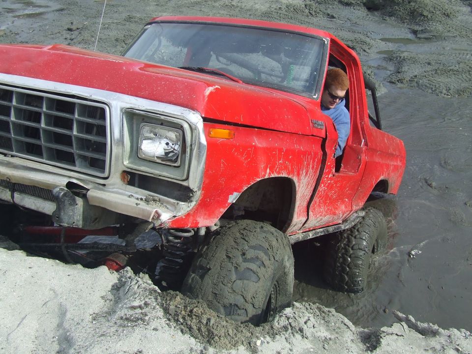 1978 Ford Bronco stuck in mud, front grille visible