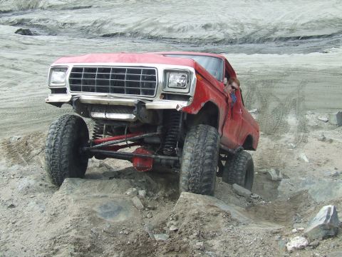 1978 Ford Bronco - This modified truck is navigating a rocky, off-road terrain.