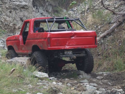 1978 Ford Bronco - This modified SUV navigates a rocky trail, showing off its off-road capabilities.