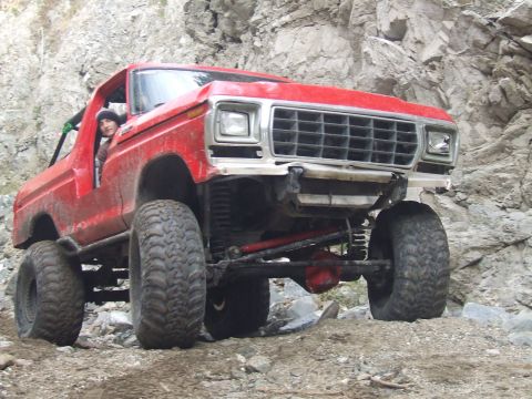 1978 Ford Bronco - This lifted 1978 Ford Bronco navigates a , rocky terrain with a driver behind the wheel.