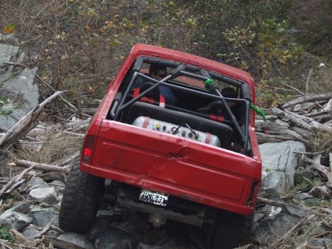 1978 Ford Bronco - This modified SUV is shown off-roading on a challenging, rocky trail.