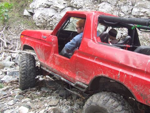 1978 Ford Bronco - This 1978 Ford Bronco navigates a challenging rocky path with its driver focused on the trail.