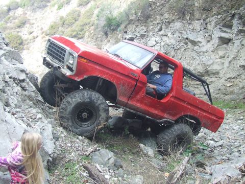 1978 Ford Bronco - This 1978 Ford Bronco is navigating a challenging off-road trail with large rocks and steep terrain.