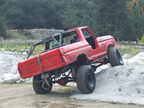1978 Ford Bronco - Modified 1978 Ford Bronco navigating a rocky trail with its suspension flexed.