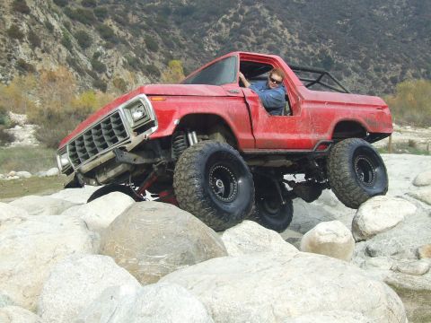 1978 Ford Bronco - This lifted 1978 Ford Bronco navigates a rocky trail, its off-road capabilities.