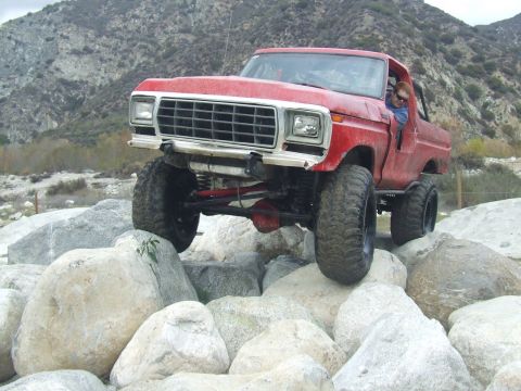 1978 Ford Bronco - Modified 1978 Ford Bronco navigating a rocky off-road trail.