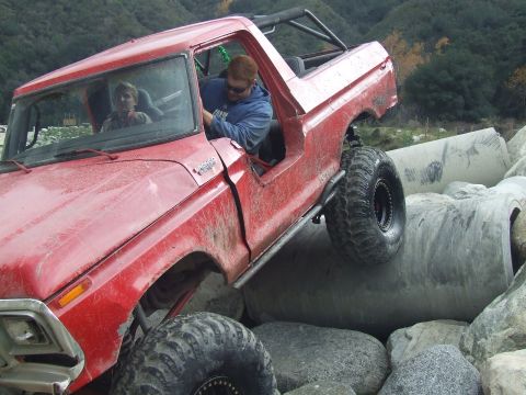1978 Ford Bronco - A red 1978 Ford Bronco navigates a rocky obstacle course.