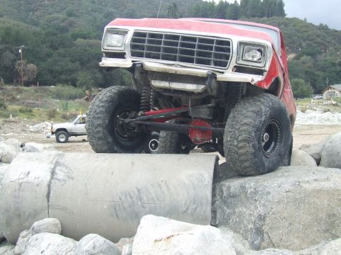 1978 Ford Bronco - Modified 1978 Ford Bronco navigating an obstacle course with large tires and suspension.