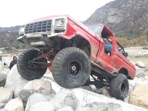 1978 Ford Bronco - This modified 1978 Ford Bronco is shown off-roading over large rocks.