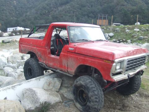 1978 Ford Bronco - This modified Bronco is navigating a rocky trail, its off-road capabilities.