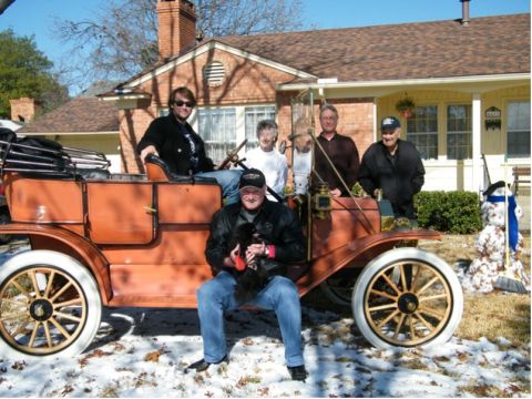 1912 Ford Model T - A group poses with an early 20th-century touring car on a snowy day.