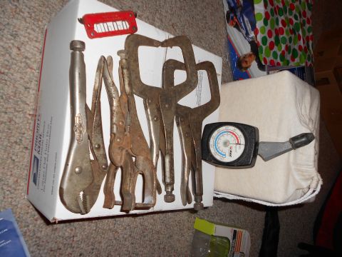 1965 Ford Mustang - A collection of various locking pliers and a gauge are laid out on a cardboard box.