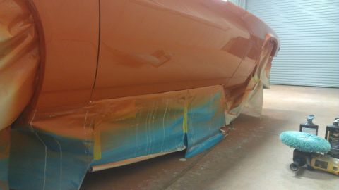 1973 Chevrolet Camaro - Car body panel undergoing painting with masking tape and protective sheeting applied.