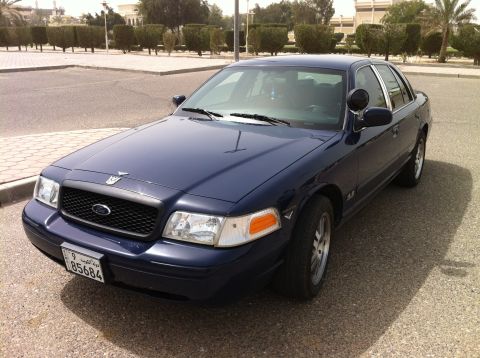 2007 Ford Crown Victoria - A dark blue 2007 Ford Crown Victoria is shown from a 3q front angle, displaying its license plate.