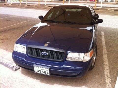 2007 Ford Crown Victoria - Front view of a dark blue 2007 Ford Crown Victoria parked in an outdoor lot.