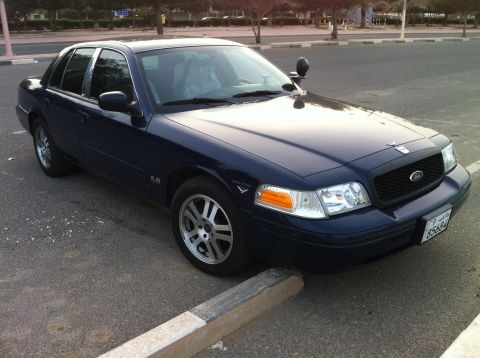 2007 Ford Crown Victoria - This 2007 Ford Crown Victoria is seen from a 3/4 front angle. The dark blue sedan has a visible license plate.