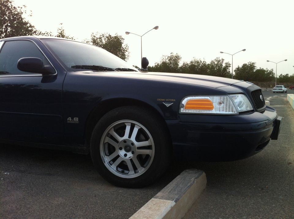 Dark blue 2007 Ford Crown Victoria parked, front quarter view. '4.6' badge visible on fender