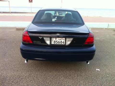 2007 Ford Crown Victoria - Rear view of a dark blue 2007 Ford Crown Victoria police car parked near the ocean.