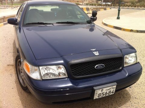 2007 Ford Crown Victoria - Dark blue Ford Crown Victoria parked outdoors, showing front grille and headlights.
