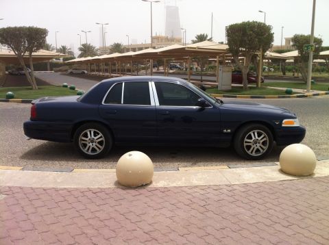 2007 Ford Crown Victoria - Side view of a dark blue 2007 Ford Crown Victoria sedan.