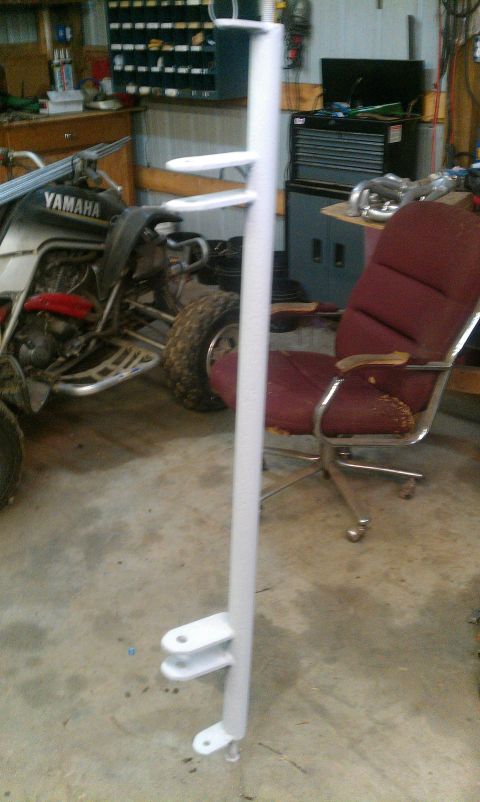 1995 Ford Bronco - White metal fabrication with mounting brackets, likely a custom part, in a workshop.