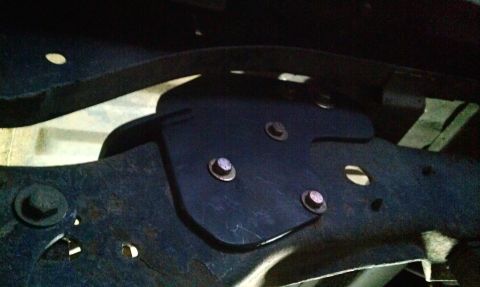 1995 Ford Bronco - Close-up of an aftermarket rear shock hoop mount on a vehicle frame.