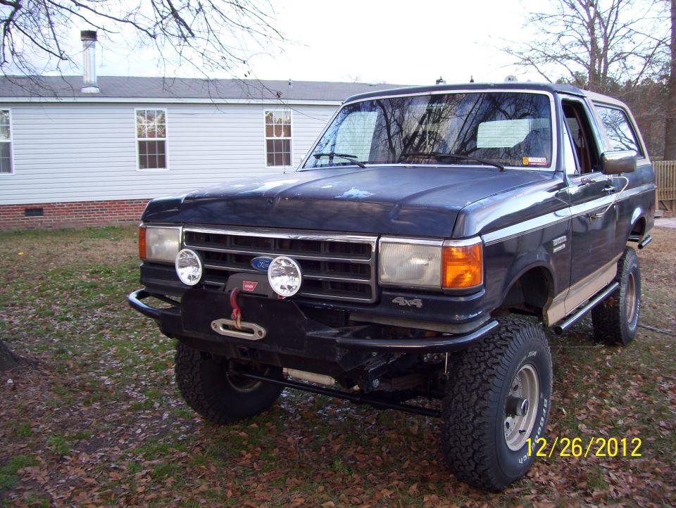 1990 Ford Bronco, 3/4 front view, dark blue with winch and aftermarket bumper