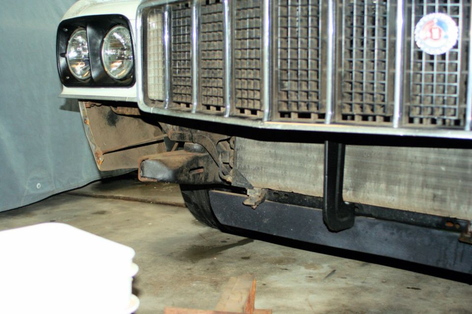 White 1972 Ford Ranchero front grille and headlights, with visible rust on fender