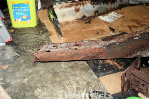 1976 Ford Ranchero - Rusted bumper and frame components are shown, with a bottle of cat litter in the background.