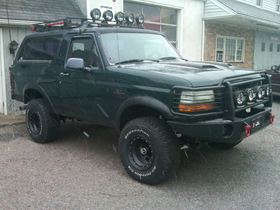 1993 Ford Bronco with roof rack, off-road lights, and bull bar