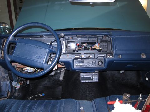 1991 Ford LTD Crown Victoria - The interior of a 1991 Ford Crown Victoria LTD shows a disassembled dashboard with exposed wiring and a blue steering wheel.