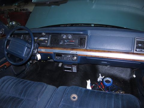 1991 Ford LTD Crown Victoria - Interior view of a 1991 Ford Crown Victoria LTD, blue velour upholstery and wood grain accents on the dashboard.