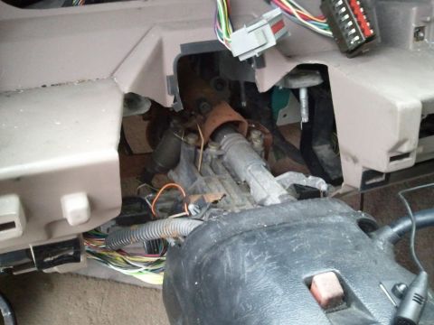 1994 Ford Bronco - The exposed steering column and a tangle of wires are visible beneath the dashboard.