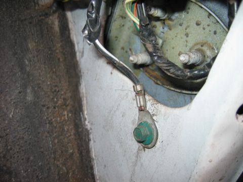 1992 Ford Bronco - A close-up view of a vehicle's electrical ground connection, showing wiring and a bolt.