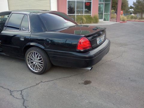 2007 Ford Crown Victoria - Rear view of a black 2007 Ford Crown Victoria, custom wheels and a spoiler.