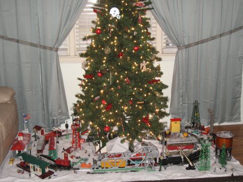 1994 Ford Bronco - A festive Christmas tree is surrounded by a detailed model train village, complete with miniature buildings and accessories.