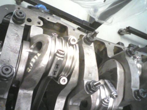 1988 Ford Mustang - Close-up view of engine crankshaft and connecting rods, with visible part markings.