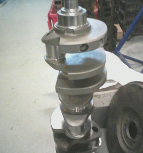 1988 Ford Mustang - A metal crankshaft, a key component of an internal combustion engine, is shown in detail.