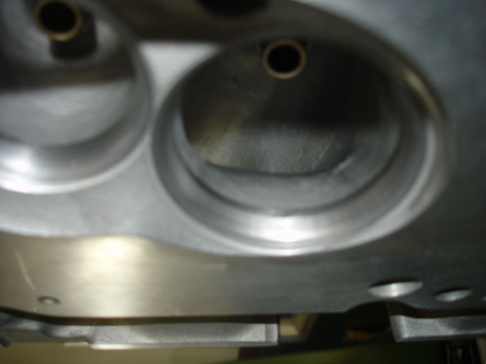 Close-up of a metal engine cylinder head with two visible ports