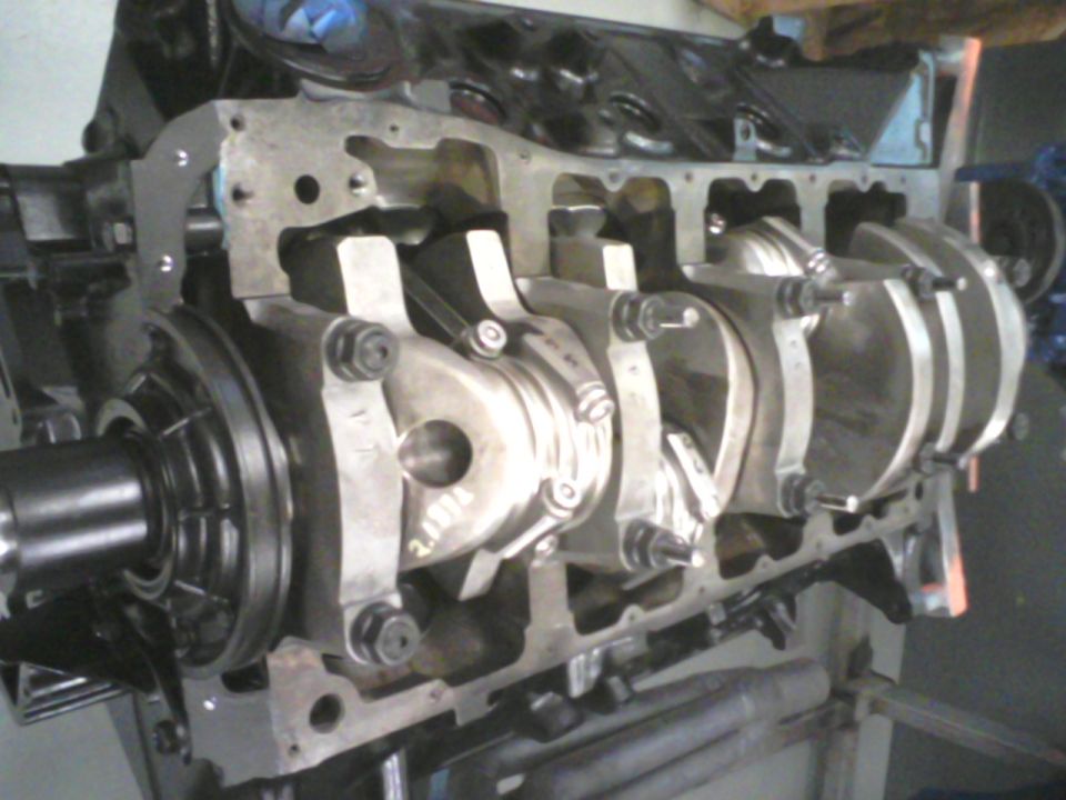 Engine block with crankshaft and connecting rods visible. Some text is visible on the crankshaft