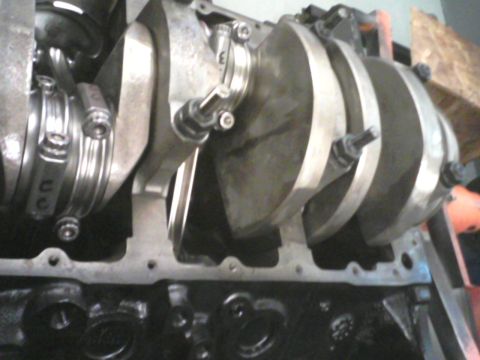 1988 Ford Mustang - Close-up view of an engine's crankshaft and connecting rods, showing internal engine components.
