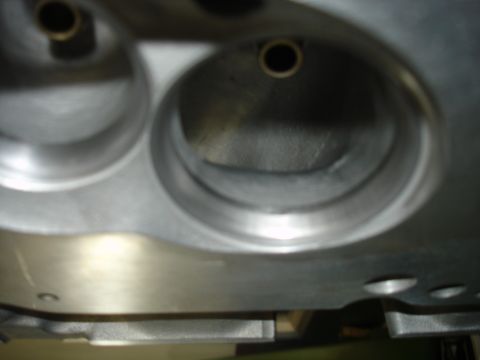 1988 Ford Mustang - Close-up of an engine cylinder head, showing internal port details and a brass fitting.