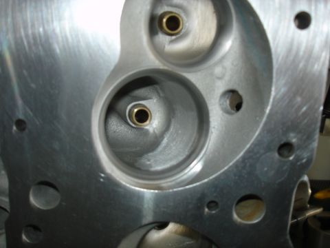 1988 Ford Mustang - Close-up view of an engine cylinder head, showing the ports for intake and exhaust valves.