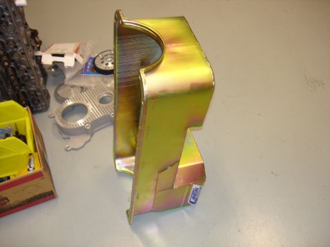 1988 Ford Mustang - A yellow oil pan with a blue label is shown, with engine parts in the background.