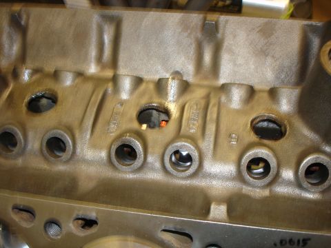 1988 Ford Mustang - Close-up view of an engine block, showing casting details and openings for internal components.