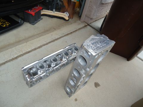 1988 Ford Mustang - Aluminum engine block and cylinder head, possibly for a performance application, sit on a concrete surface.