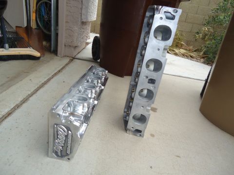 1988 Ford Mustang - Pair of Ford Motorsport aluminum cylinder heads on a concrete surface.