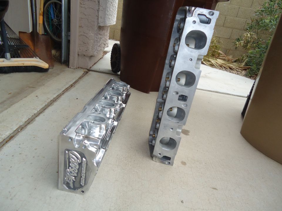 Two aluminum engine cylinder heads, one with 'Ford Motorsport' visible