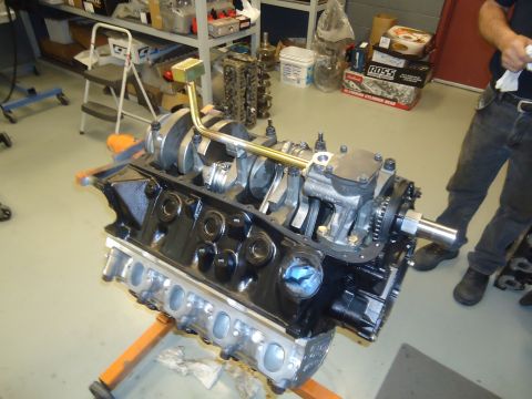 1988 Ford Mustang - An engine block assembly is displayed on a stand in a workshop environment.